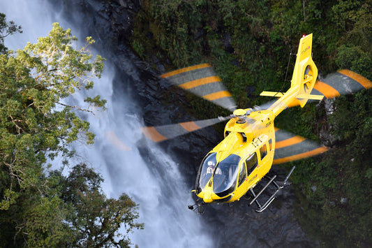 Helicopter Tours - Helicioter flying over waterfall