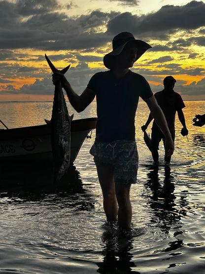 Deep Sea Fishing fisherman coming home with their catch at dusk