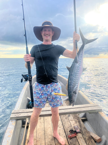 Deep Sea Fishing holding up a mackerel