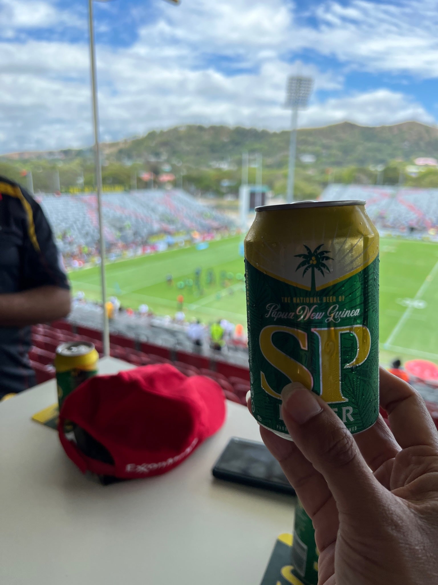 PNG Hunters holding an SP Lager can in the club lounge